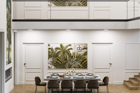 Modern dining room with tropical wall art, elegant staircase, and a herringbone pattern floor. Step into a dining space where contemporary design meets tropical allure. This refined dining room, part of our latest design collection, features a striking wall art centerpiece that draws the eye with its lush palm imagery, set against a backdrop of pristine white walls and sleek cabinetry. The room is anchored by a stunning herringbone patterned floor, offering both warmth and sophistication. Overhead, a mezzanine with clean lines and glass balustrades adds a touch of modern architecture, while the cozy dining chairs invite guests to linger over meals. The careful interplay of light and shadow, the elegant furnishings, and the bold yet inviting art piece make this dining area not just a place to eat but a statement in style. It's an invitation to embrace the beauty of modern living while enjoying the comforts of home.