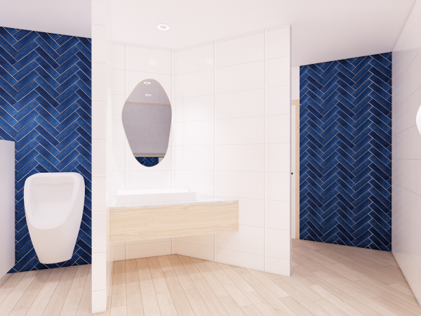 Contemporary men's washroom featuring sleek white fixtures, herringbone-patterned blue tiles on the wall, and light wooden flooring. This image presents a modern men's washroom design that balances functionality with bold aesthetic choices. The striking herringbone pattern of deep blue tiles creates a dynamic focal wall, contrasted against the pristine white of the surrounding walls and sanitary fixtures. Light wooden elements, seen in the vanity and flooring, infuse warmth into the space, softening the sharp lines of the white surfaces. The mirror, with its unique shape and gray border, adds a sophisticated and contemporary touch. This washroom design exudes a clean, crisp ambiance while the geometric tiles add an energetic burst of color and pattern, showcasing a confident approach to commercial interior design.