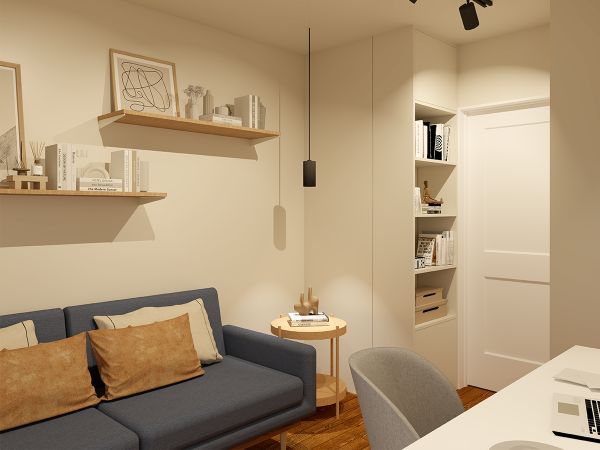 Home office with a gray couch, side table, and built-in bookshelf.