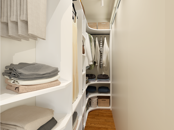 A small, white corner closet with shelves and hanging rods.