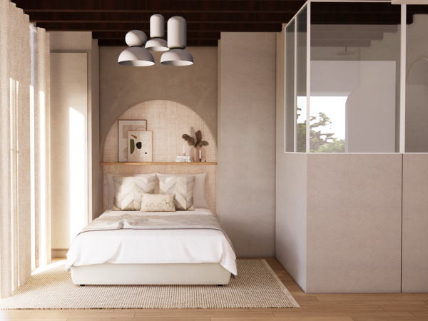 A cozy bedroom with a bed, a small reading nook, and a glass partition.