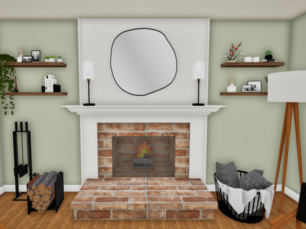 Living room with a brick fireplace, black log storage unit, minimalist wooden shelves with decor, and a large circular mirror above the mantle. The space also includes a floor lamp, a black wire basket with pillows, and a green accent wall.