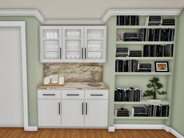 A home bar area with white cabinetry, marble countertop, glassware, and a small sink. Beside it, a bookshelf displays black books, a bonsai plant, and framed artwork, complemented by green walls and wood flooring.